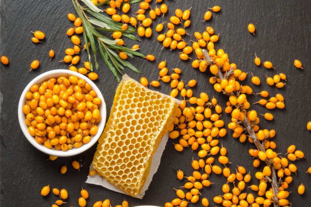 Top down view of honey and other yellow seeds.